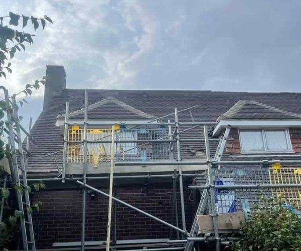 This is a photo of a roof with two dormers that is having some damaged tiles replaced. Works carried out by EDS Roofing Stainforth